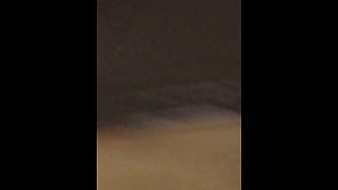 Bundled up teen flexes for the mirror