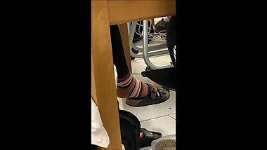 Candid Birkenstock crossed ankle and dangling shoeplay